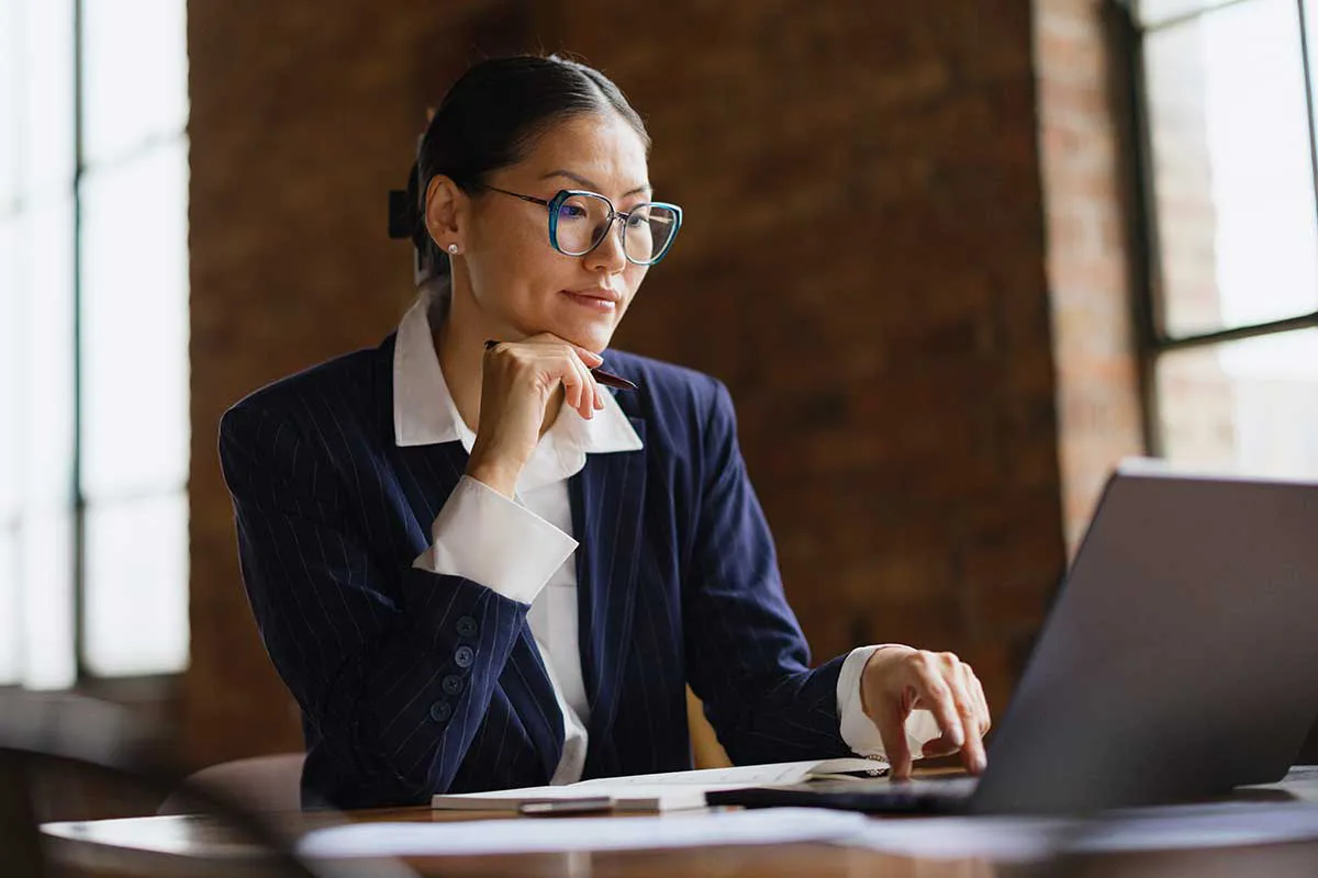 A businesswoman working on a laptop computer.