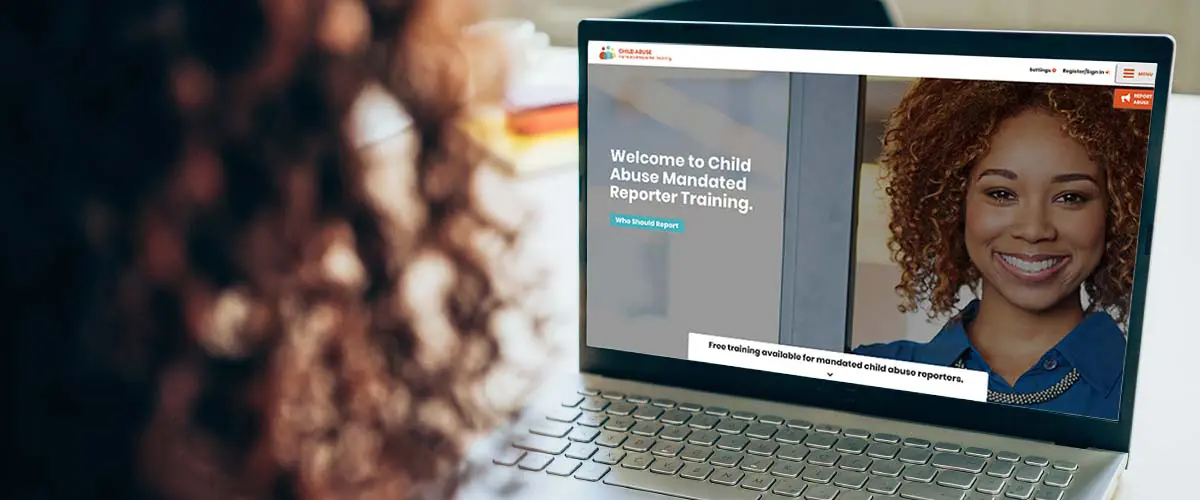 The side profile of a person with curly hair looking at the Mandated Reporter Training website.